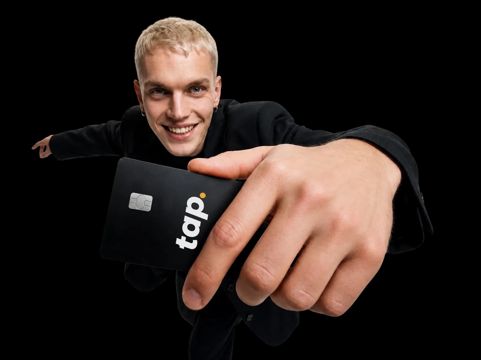 Smiling person extending a Tap card toward the camera